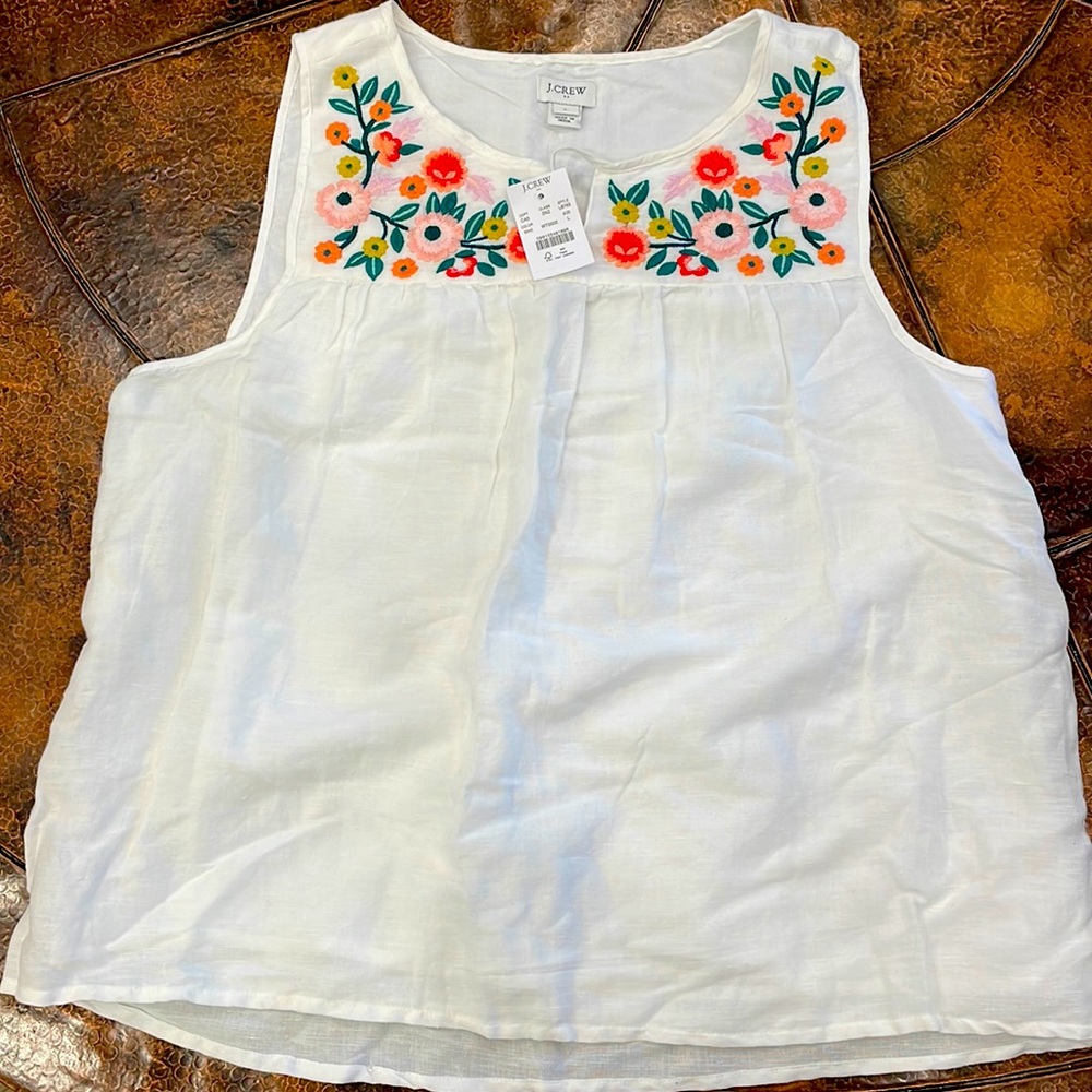 Women’s sleeveless top with embroidered flowers on top